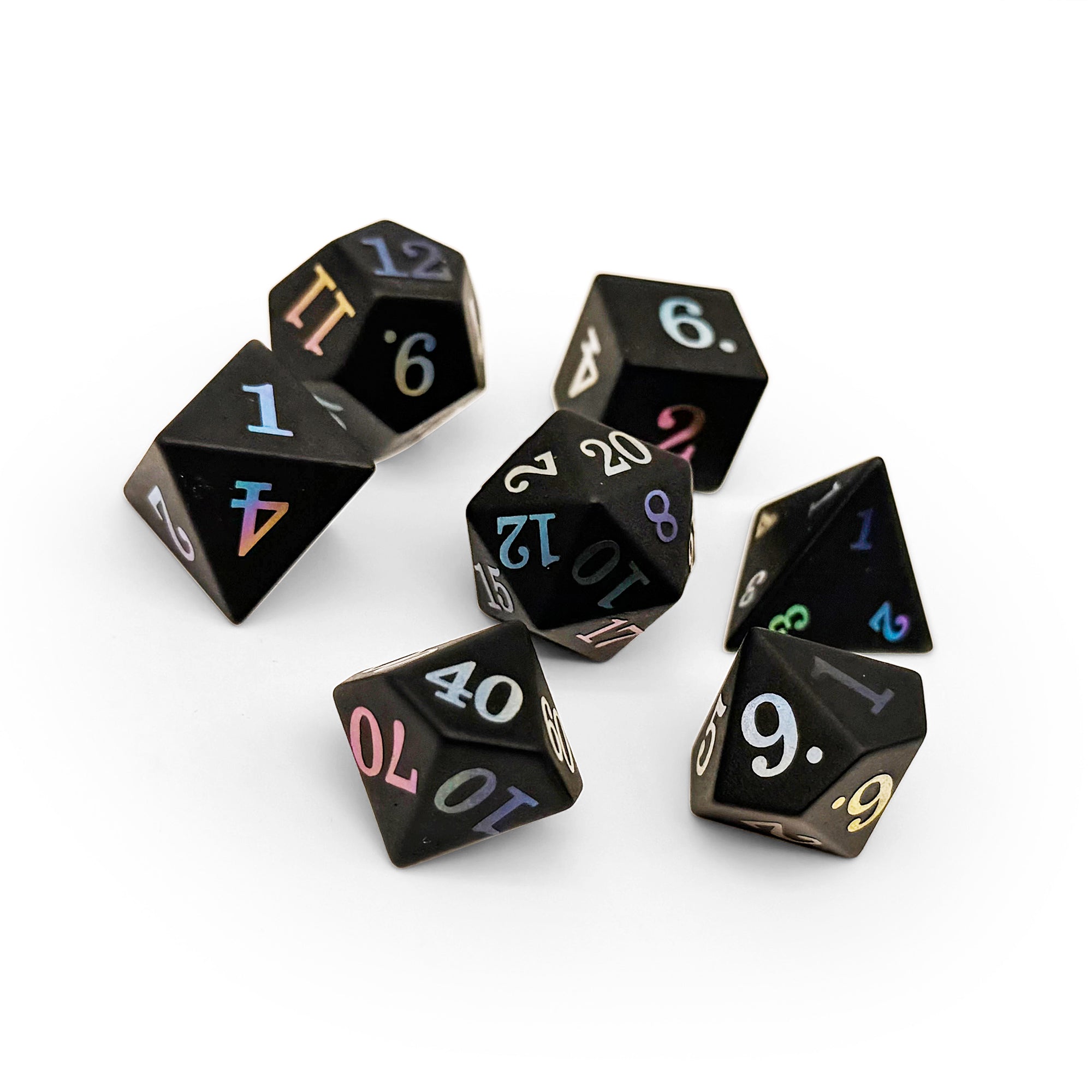 Set of black polyhedral dice with colorful numbers on a white background